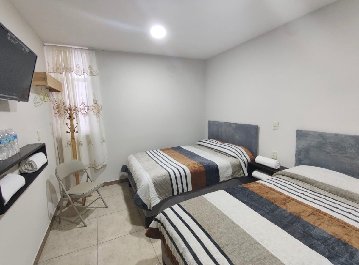 Habitación Doble con dos camas matrimoniales para grupo o familia.